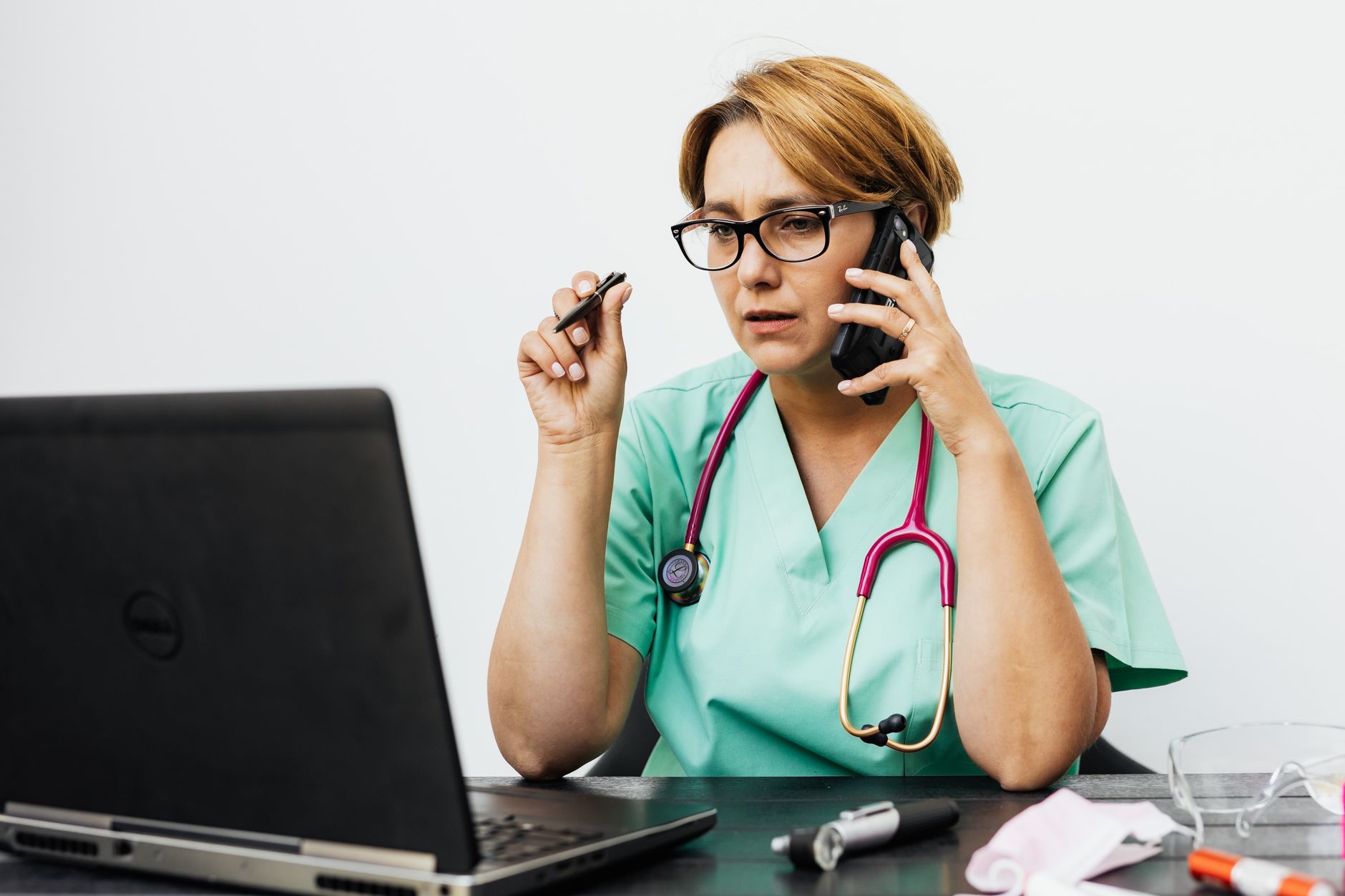 A practice manager reviewing call transcripts on a laptop dashboard in a clinic office