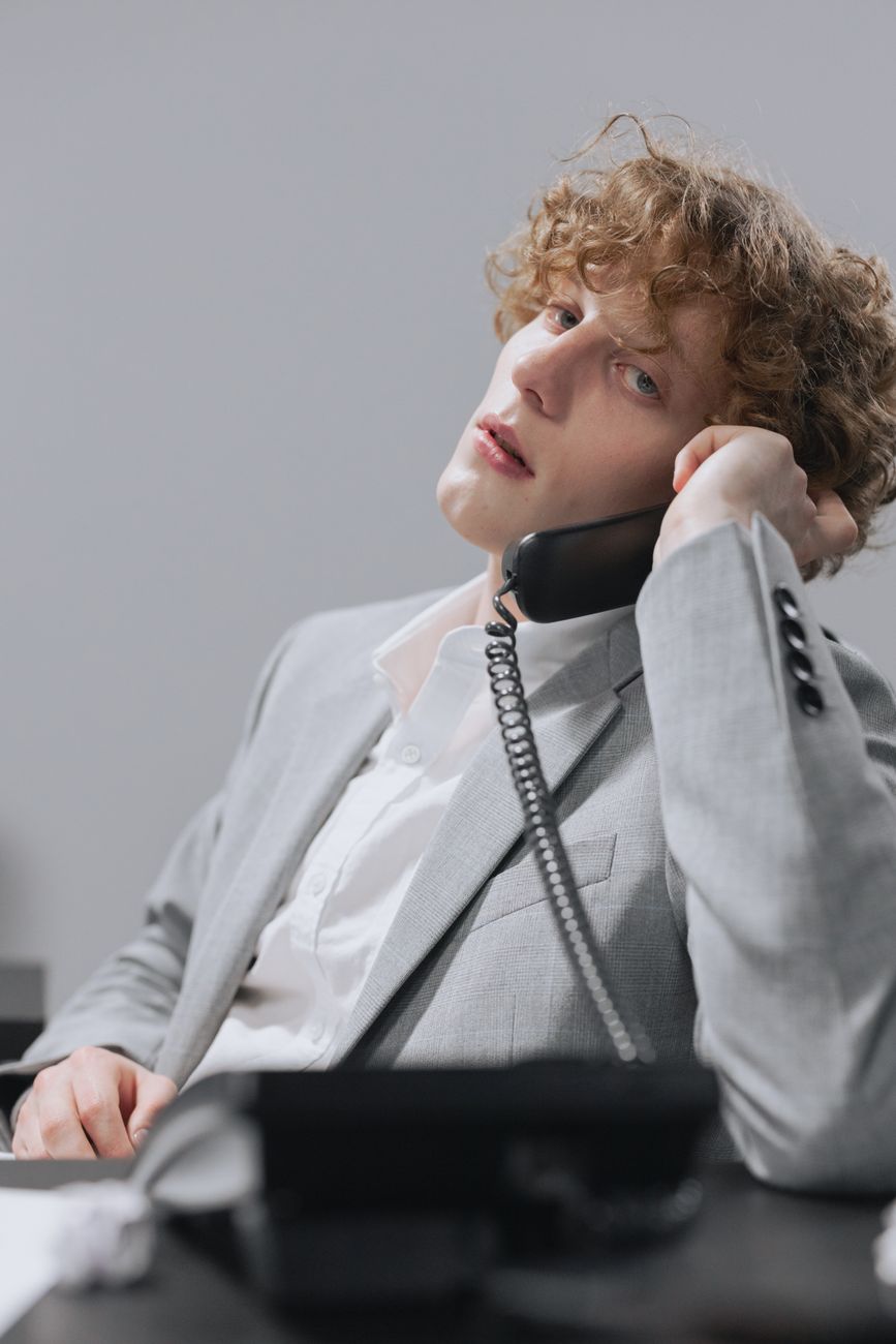 An unattended office reception desk phone ringing, representing missed call challenges for small businesses