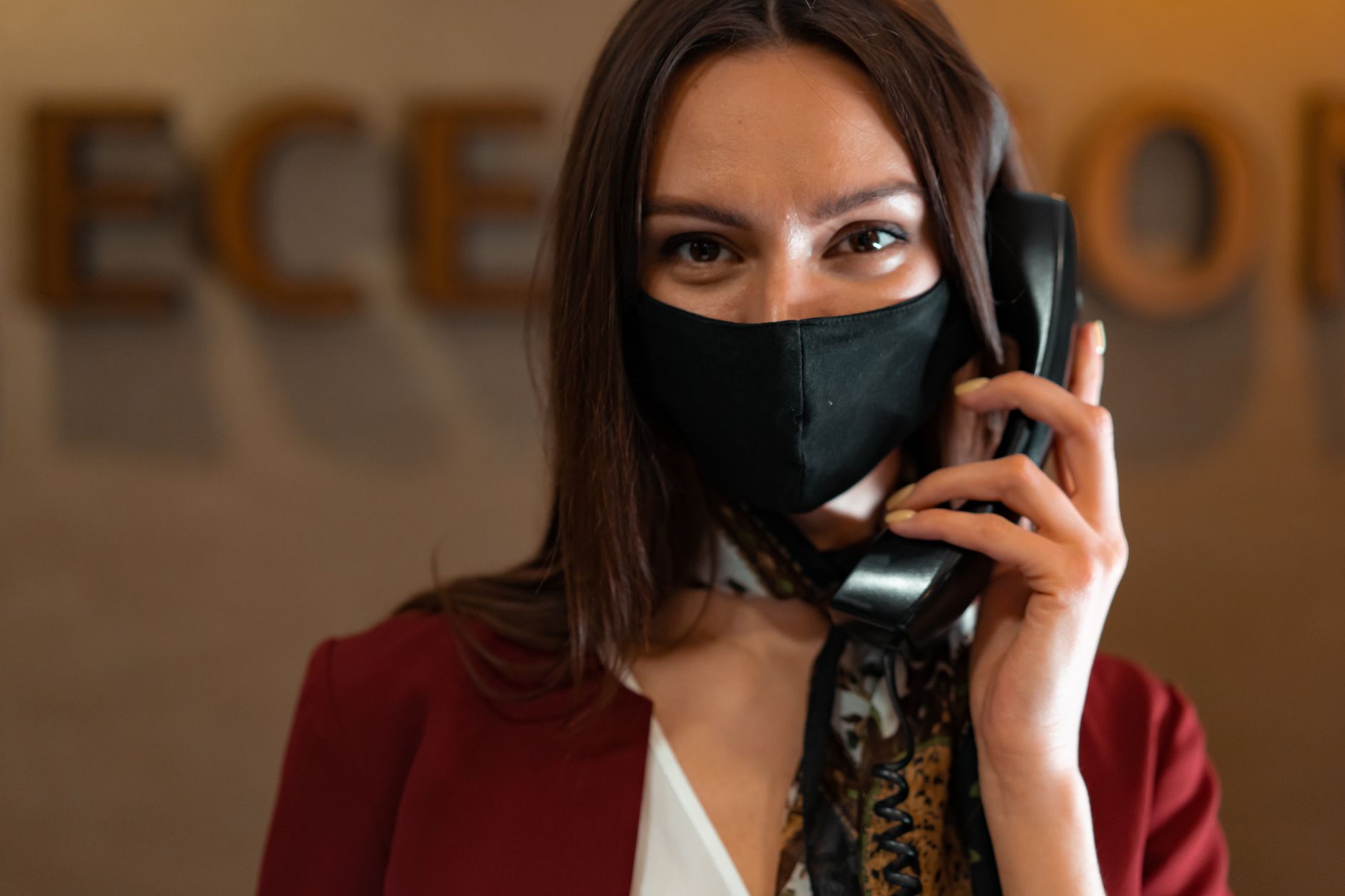 Receptionist answering a phone call at a front desk