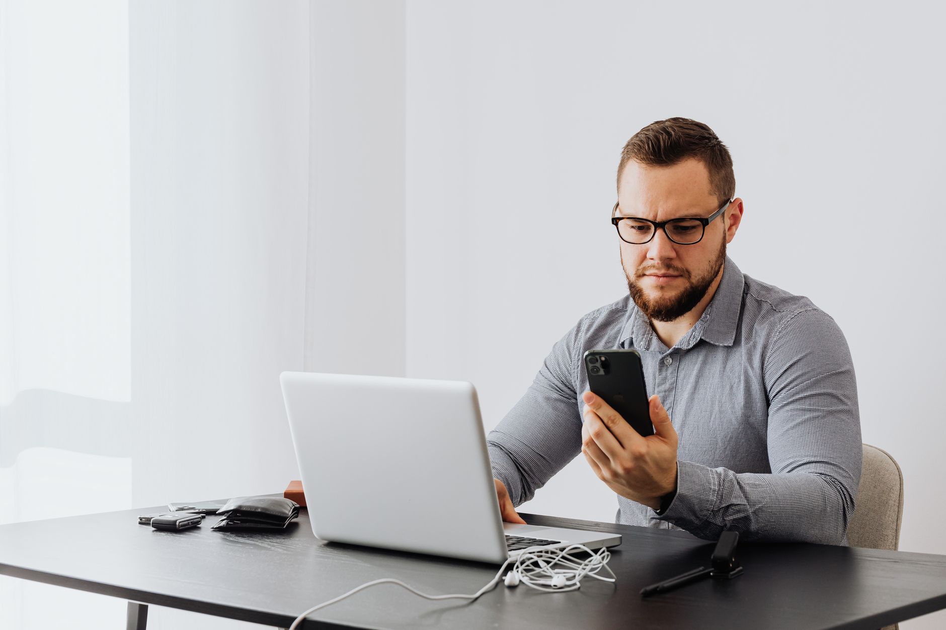 Person reviewing a call dashboard on a laptop next to an office phone