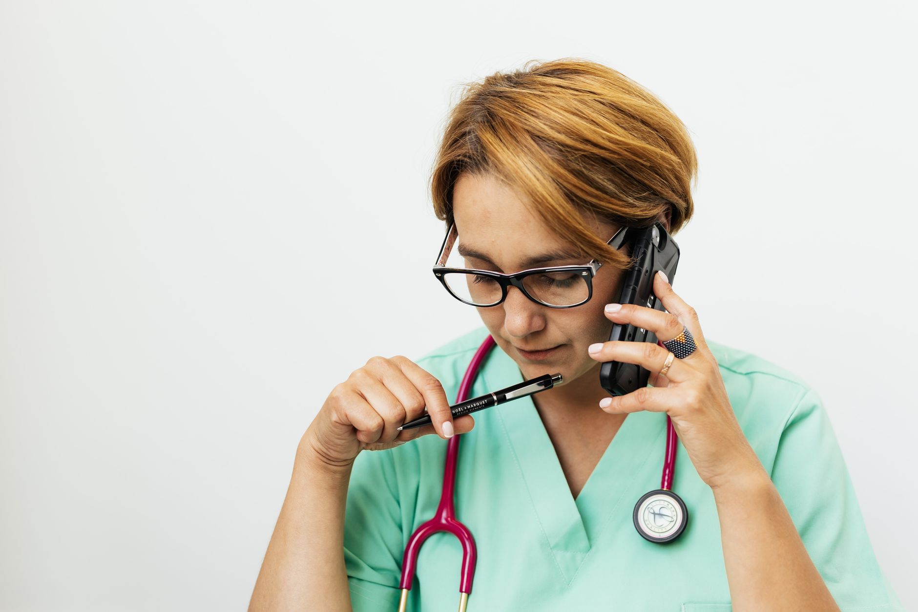Physical therapy clinic staff member on the phone scheduling a patient appointment