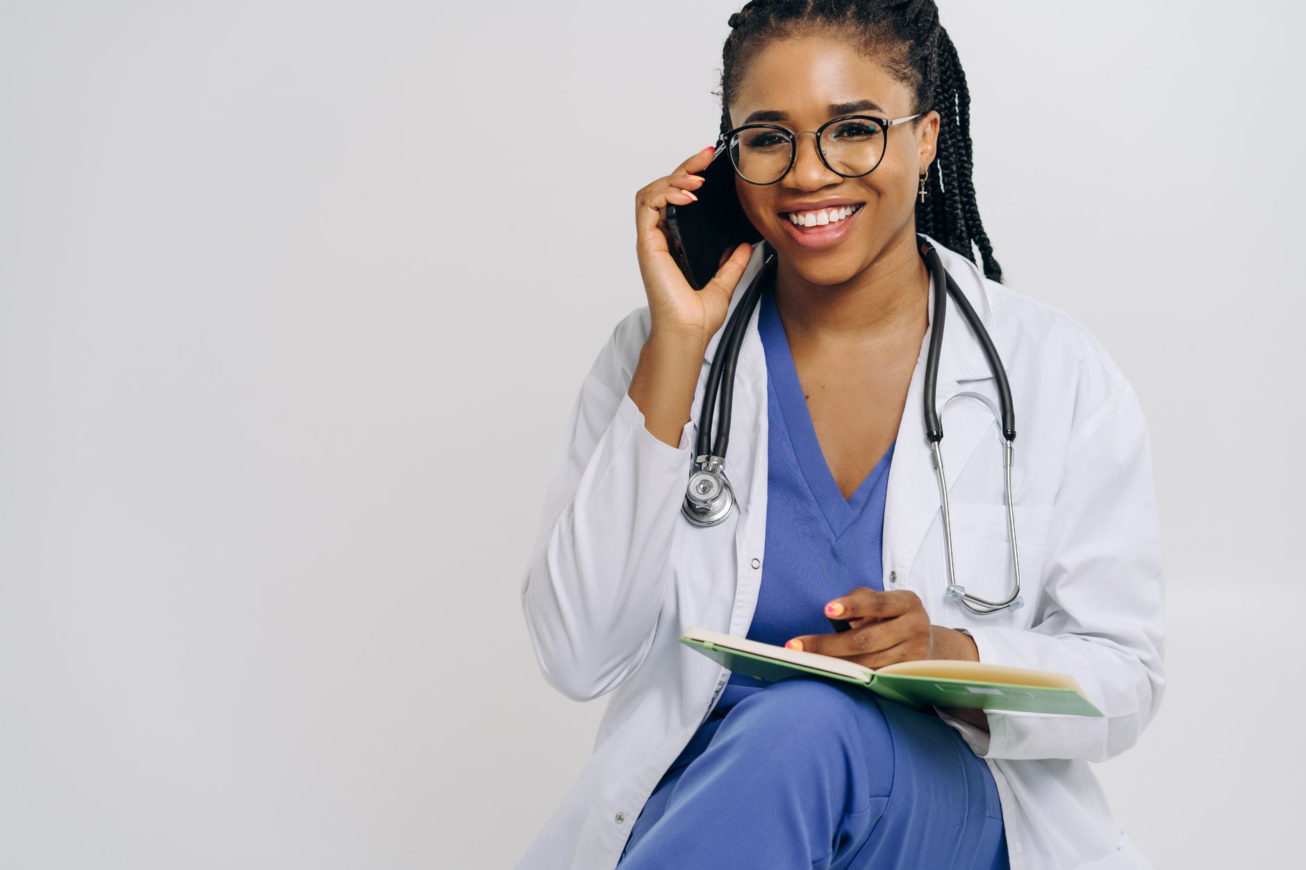 Aesthetics clinic staff member on the phone booking a consultation appointment