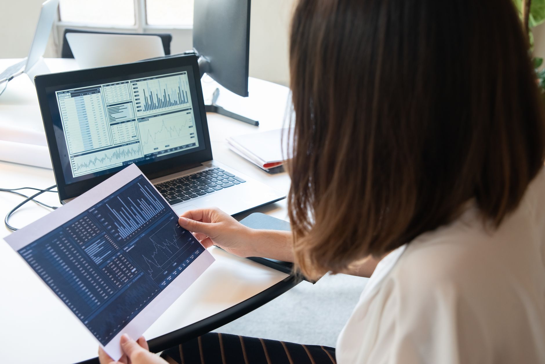 Business owner reviewing call dashboard and analytics on a laptop